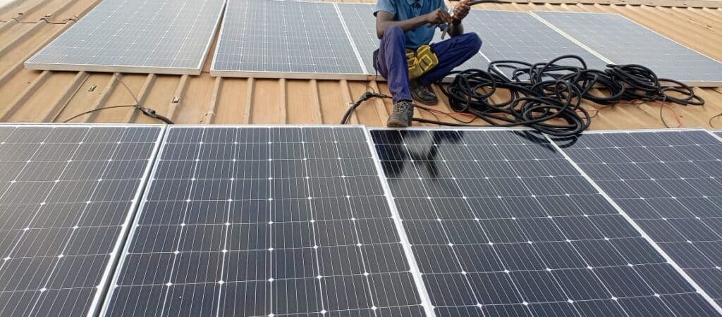 LumaGrid installer fixing solar panels on a roof